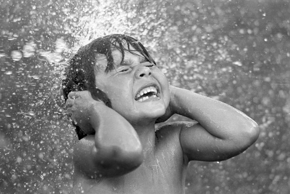 June 16, 1980: Adam Coca, 6, is splashed during a water battle as the high temperature hit 100 degrees in Fort Worth. Larry C. Price/Fort Worth Star-Telegram archive/UT Arlington Special Collections