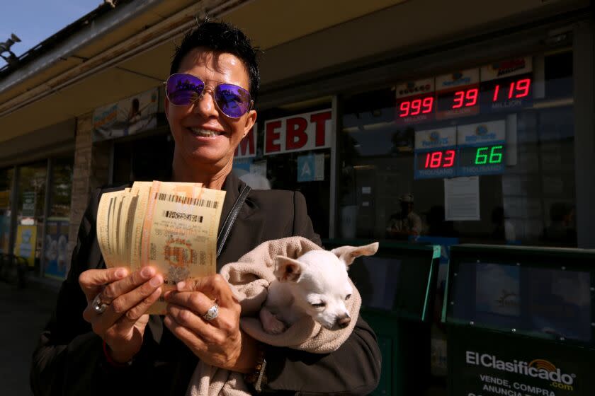 Realtor Alicia Sanchez, her dog and $200 worth of Powerball tickets that she and her coworkers purchased in Hawthorne