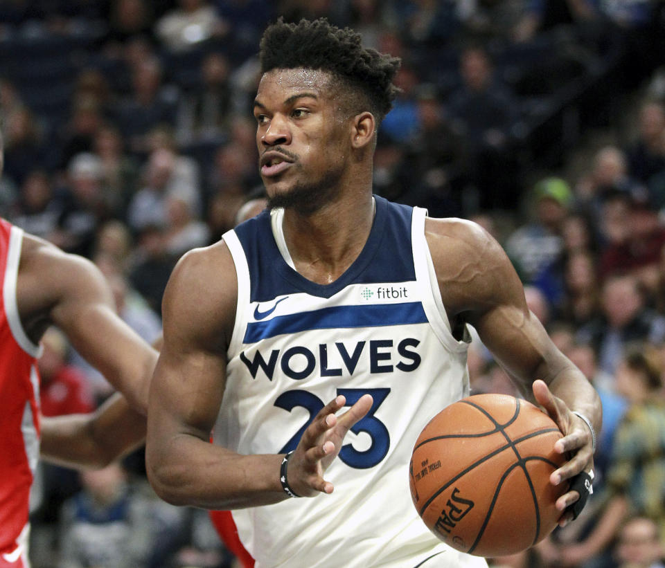 FILE - In this Feb. 13, 2018, file photo, Minnesota Timberwolves guard Jimmy Butler (23) drives against the Houston Rockets during an NBA basketball game, in Minneapolis. The Timberwolves, trying to build off the fresh-start vibe behind 32-year-old interim head coach Ryan Saunders, are ready to show Jimmy Butler what he's been missing. The Wolves play at Philadelphia on Tuesday, Jan. 15, 2019, facing Butler for the first time since he was traded to the 76ers two months ago. (AP Photo/Andy Clayton-King, File)