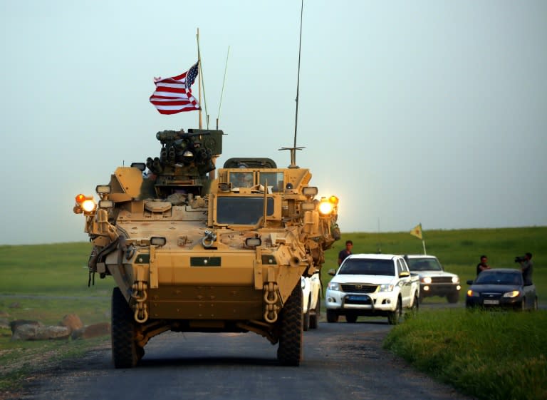 US forces, accompanied by Kurdish People's Protection Units (YPG) fighters, drive their armoured vehicles near the northern Syrian village of Darbasiyah, on the border with Turkey on April 28, 2017