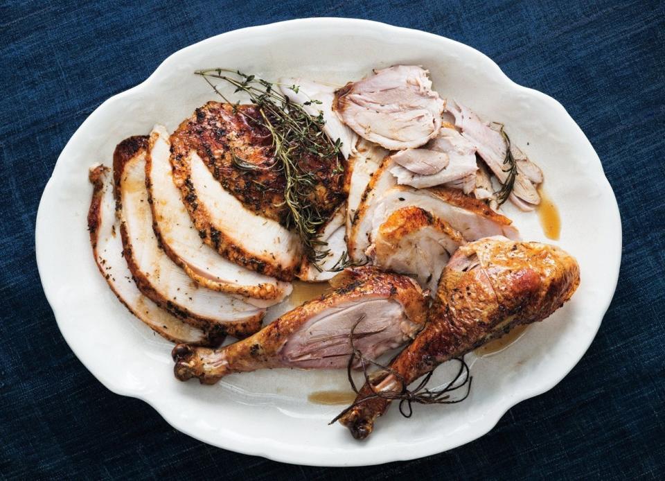 This is a good option for cold-weather Thanksgivings eaten under threatening skies, since the combination of herbs and citrus provides a house-filling aroma that speaks to sunniness. Garnish with some remaining sprigs of sage and thyme, but be careful with the rosemary, as a little goes a long way. <a href="https://www.bonappetit.com/recipe/herb-roasted-turkey?mbid=synd_yahoo_rss" rel="nofollow noopener" target="_blank" data-ylk="slk:See recipe.;elm:context_link;itc:0;sec:content-canvas" class="link ">See recipe.</a>