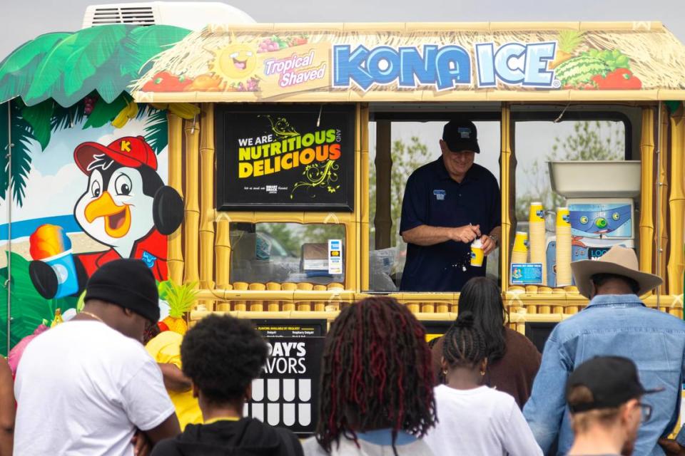 A line forms at the Kona Ice stand giving out free shaved ice at the Como Community Center in Fort Worth on Saturday, April 8, 2023.