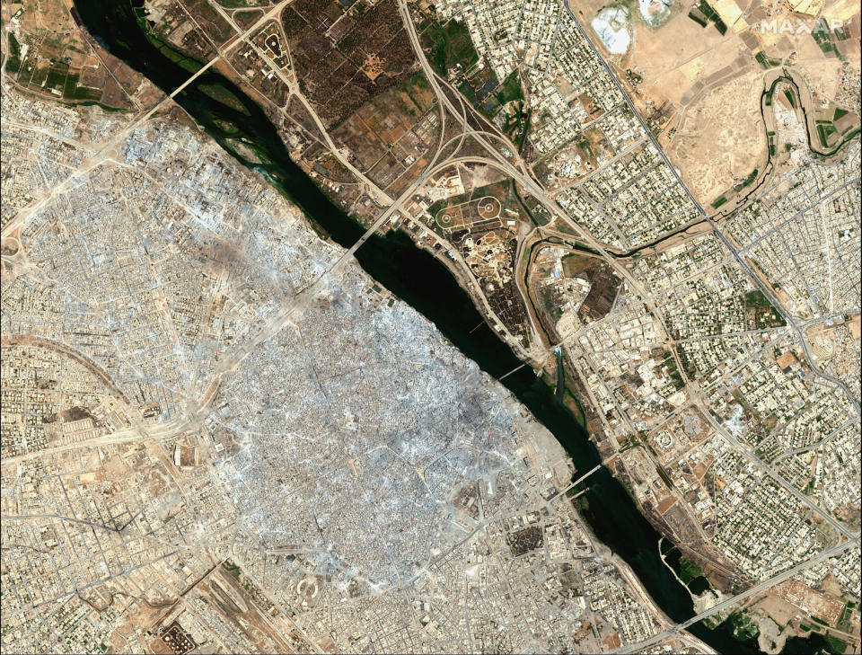 This July 8, 2017, image provided by Maxar Technologies shows the Old City of Mosul, Iraq, left, after a punishing nine month battle to oust Islamic State militants. (Satellite image ©2019 Maxar Technologies via AP)