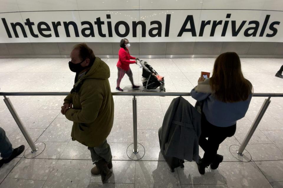 International passengers walk through the arrivals area at Terminal 5 at Heathrow Airport on 26 November where flights to six African countries have been suspended (Getty Images)