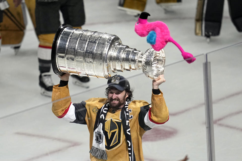 Vegas Golden Knights right wing Mark Stone skates with the Stanley Cup as a stuffed flaming is thrown after the Knights defeated the Florida Panthers 9-3 in Game 5 of the NHL hockey Stanley Cup Finals Tuesday, June 13, 2023, in Las Vegas. The Knights won the series 4-1. (AP Photo/Abbie Parr)