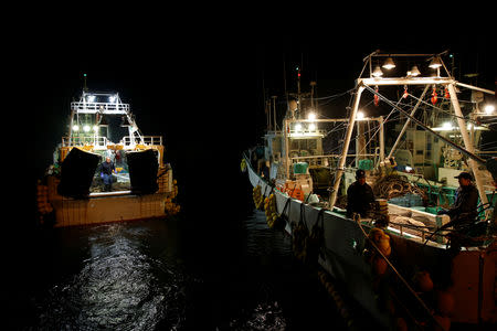 Fishermen boarding trawlers leave for a trial fishing operation at Matsukawaura fishing port in Soma, Fukushima prefecture, Japan February 20, 2019. Picture taken February 20, 2019. REUTERS/Issei Kato