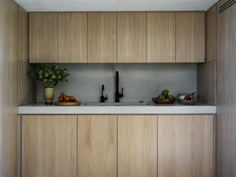 “I like everything to go away; I don’t like anything outside of cupboards, or open shelves. I like everything behind a wall,” says Rice. That proclivity for having things hidden informed the significant kitchen renovation, which also made for more space. Bleached white oak cabinetry obscures all appliances against plaster walls, ceiling, and countertops. “It was all about making the space feel better, more continuous,” says Alexander of the heart of the house. The fixtures are by Brizo.