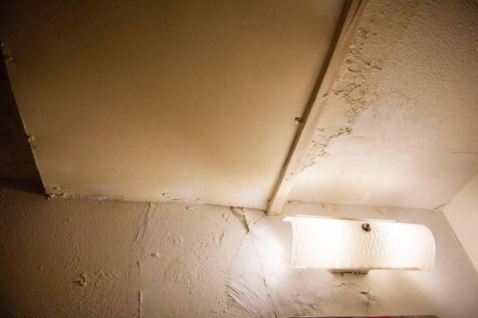 Dry plaster and wall damage are visible in the bathroom of Michelle Paylor’s studio apartment at Independence Towers on Tuesday, March 19, 2024, in Independence.