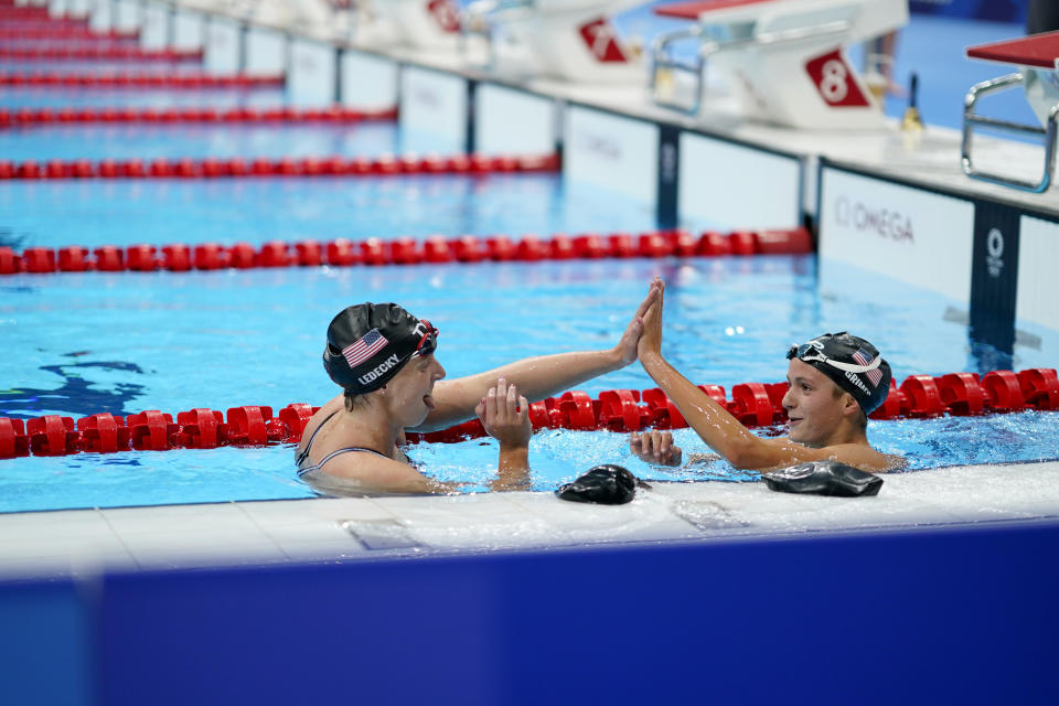 Kathleen Ledecky, of the United States, left high-fives teammate Katie Grimes after Ledecky won the women's 800-meter freestyle final at the 2020 Summer Olympics, Saturday, July 31, 2021, in Tokyo, Japan. (AP Photo/David Goldman)