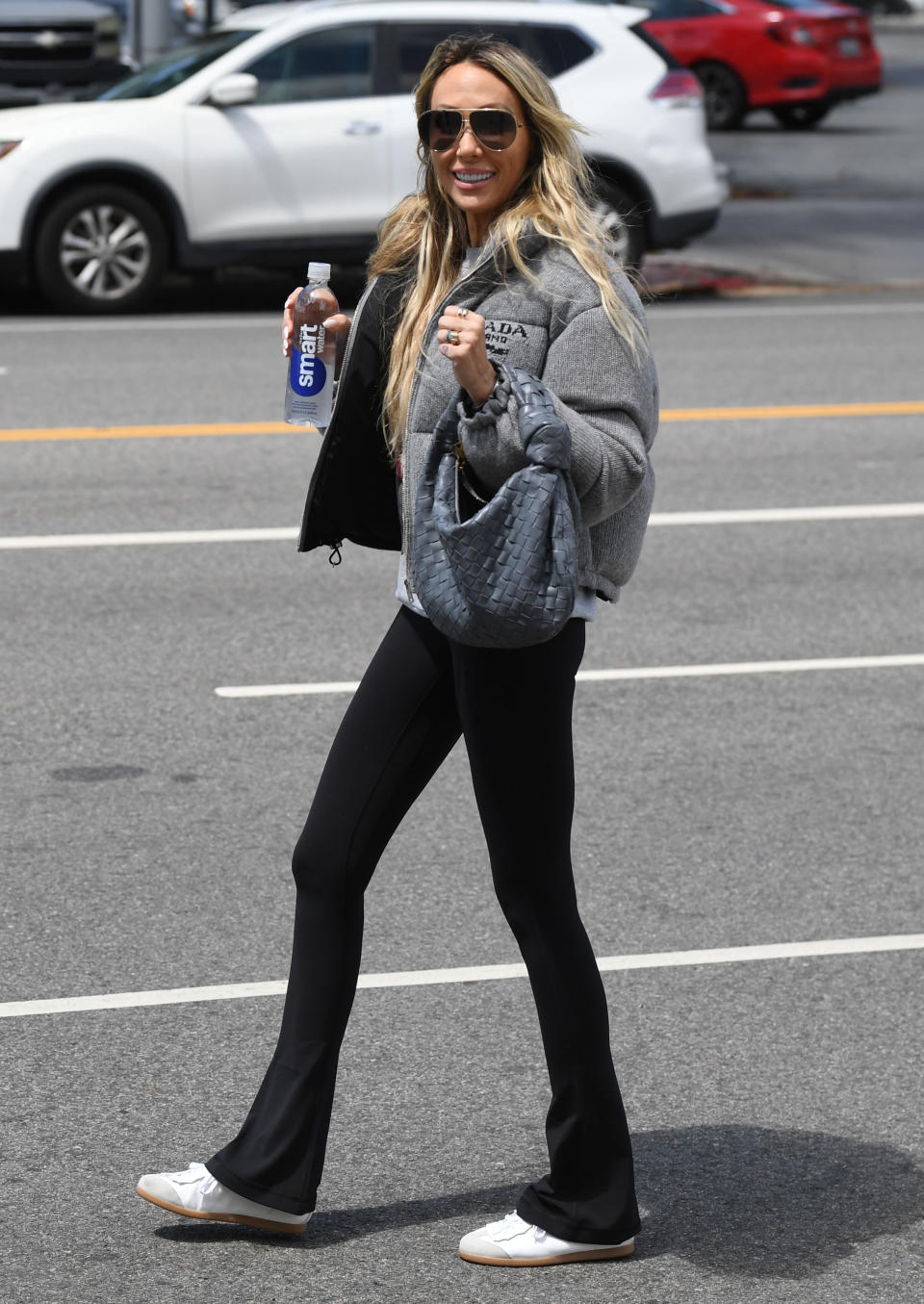 Tish Cyrus walking down the street