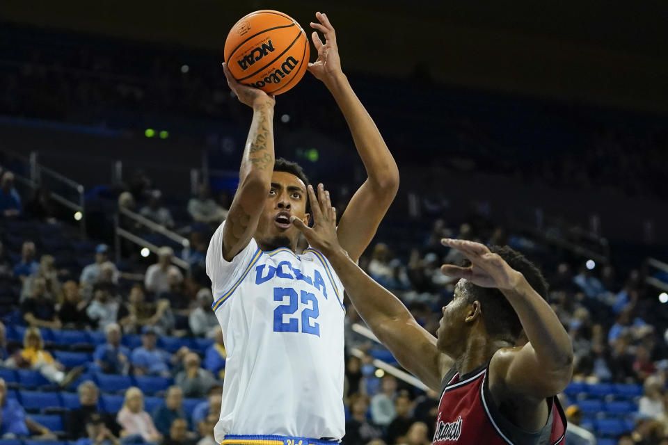 UCLA forward Devin Williams, left, shoots as St. Francis forward Gestin Liberis defends during the first half of an NCAA college basketball game, Monday, Nov. 6, 2023, in Los Angeles. (AP Photo/Ryan Sun)