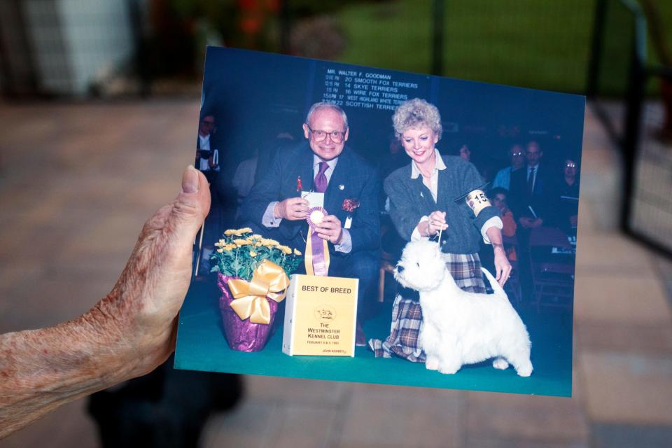 Bergit Coady-Kabel holds a 1993 photograph of herself and Walter Goodman, at her Indio, Calif., home on November 15, 2021. Coady-Kabel won Best of Breed in the 1993 Westminster Kennel Club Dog Show. 