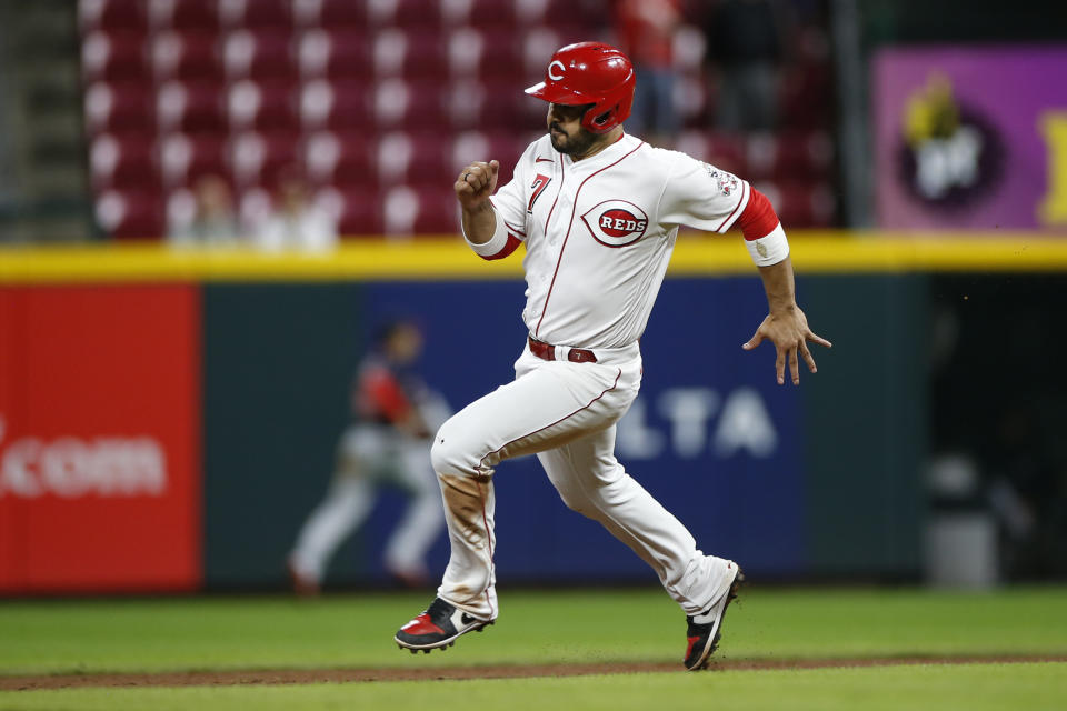 Cincinnati Reds' Eugenio Suarez scores from first base after Max Schrock hit a triple against the Washington Nationals during the ninth inning of a baseball game Thursday, Sept. 23, 2021, in Cincinnati. The Nationals beat the Reds 3-2. (AP Photo/Jay LaPrete)