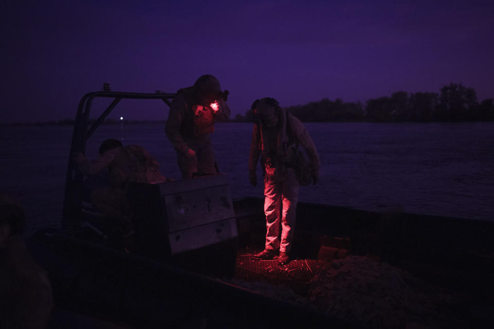 Ukraine Special Operations Forces soldiers check a Russian boat they captured on the Dnipro River during a night mission in Kherson region, Ukraine, Saturday, June 10, 2023. (AP Photo/Felipe Dana)