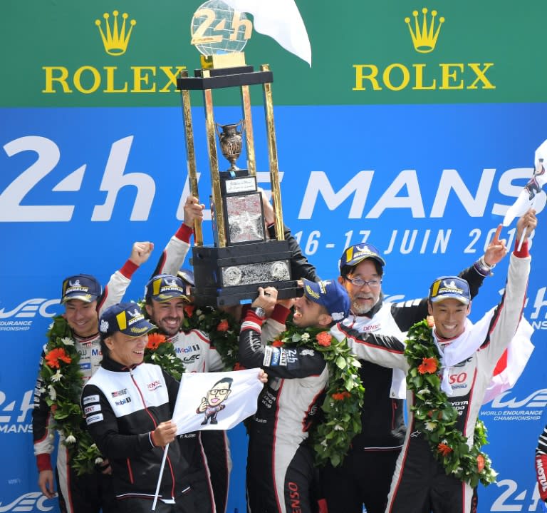 The six drivers from the two Toyota cars celebrated together after finishing first and second at Le Mans