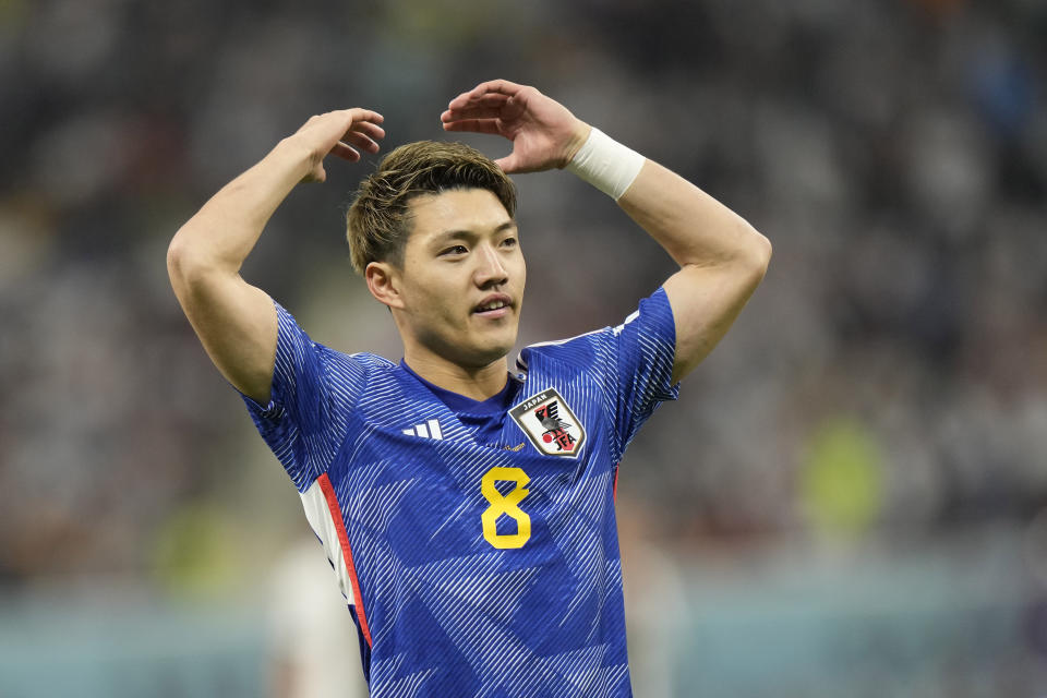 Japan's Ritsu Doan celebrates after scoring his side's opening goal during the World Cup group E soccer match between Germany and Japan, at the Khalifa International Stadium in Doha, Qatar, Wednesday, Nov. 23, 2022. (AP Photo/Luca Bruno)