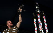 <p>Sweepee Rambo the dog is held aloft by his owner after cruising to victory in the ugly dog contest. (Photo by Justin Sullivan/Getty Images)</p>