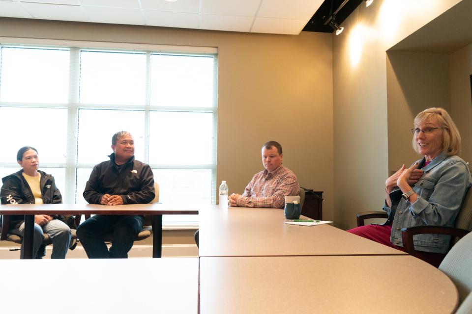 Marsha Pope, right, president of the Topeka Community Foundation, talks about why affordable housing in the area is important and how, from left, Dina and Reden Jalosjos, owners of Reden Construction and Property Management, are creating that in North Topeka. Also pictured is Ben Murphy, president of Alliance Bank.