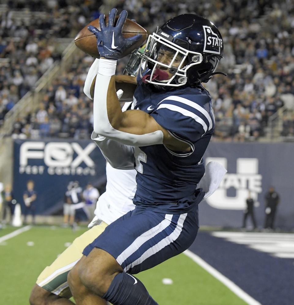 Utah State wide receiver Micah Davis catches a touchdown pass as Colorado State defensive back Dom Jones defends during the second half of an NCAA college football game Saturday, Oct. 7, 2023, in Logan, Utah. | Eli Lucero/The Herald Journal via AP