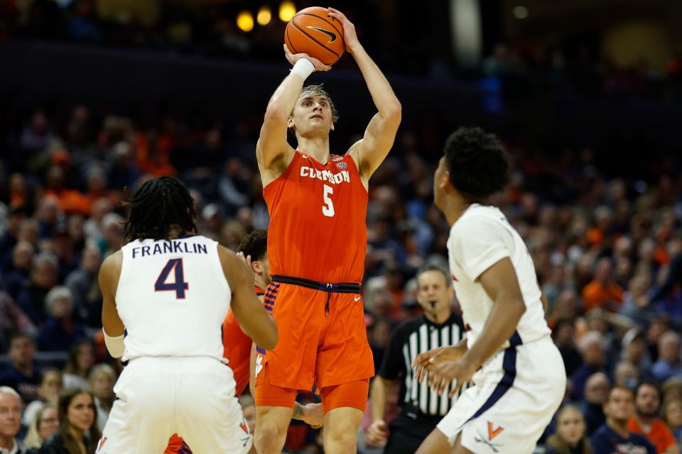 Feb 28, 2023; Charlottesville, Virginia, USA; Clemson Tigers forward Hunter Tyson (5) shoots the ball as Virginia Cavaliers guard Armaan Franklin (4) and Cavaliers guard Reece Beekman (2) defend in the first half at John Paul Jones Arena. Mandatory Credit: Geoff Burke-USA TODAY Sports