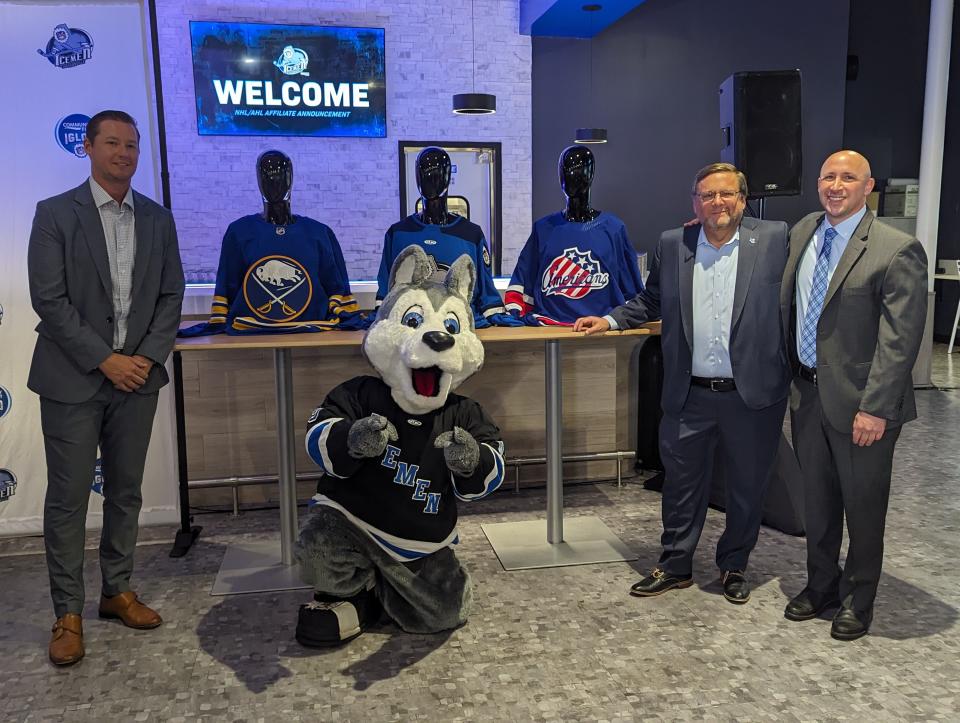 From left, Jacksonville Icemen coach Nick Luukko, mascot Fang, team president Bob Ohrablo and chief executive officer Andy Kaufmann line up with hockey sweaters of the Buffalo Sabres, the Icemen and the Rochester Americans on Monday.