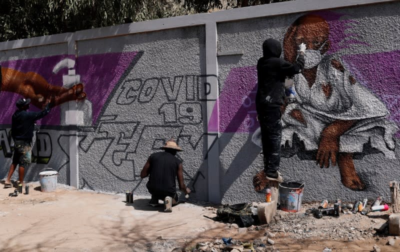 Graffiti artists from RBS crew work on their mural to encourage people to protect themselves amid the outbreak of the coronavirus disease (COVID-19), in Dakar