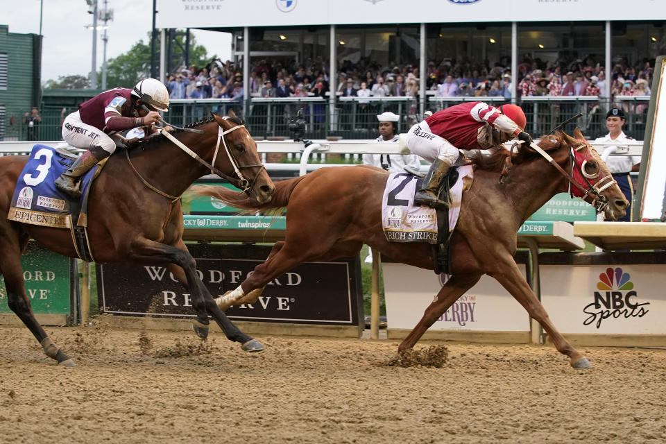 Rich Strike (21), with Sonny Leon aboard, beats Epicenter (3), with Joel Rosario aboard, at the finish line to win the 148th running of the Kentucky Derby horse race at Churchill Downs Saturday, May 7, 2022, in Louisville, Ky. (AP Photo/Mark Humphrey)