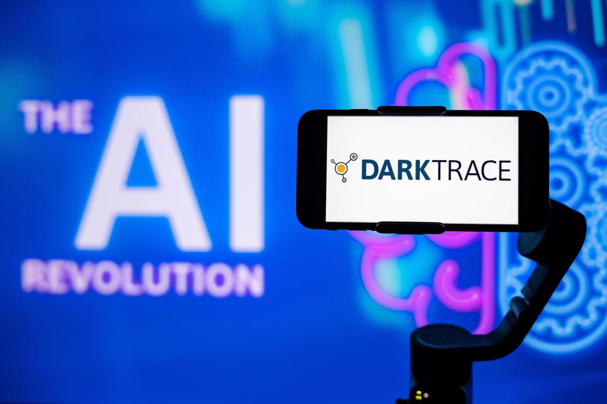 India. 27th Jan, 2021. In this photo illustration, the logo of Darktrace is seen displayed on a mobile phone screen with The AI (artificial intelligence) revolution written in the background. Credit: SOPA Images Limited/Alamy Live News