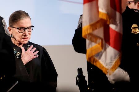 Associate Justice of the U.S. Supreme Court Ruth Bader Ginsburg stands during the National Anthem at the U.S. Citizenship and Immigration Services (USCIS) naturalization ceremony at the New York Historical Society Museum and Library in Manhattan, New York, U.S., April 10, 2017. REUTERS/Shannon Stapleton/Files