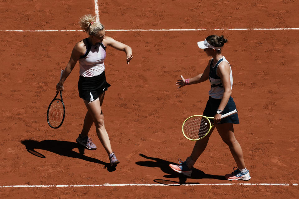 Czech Republic's Barbora Krejcikova,right, and compatriot Katerina Siniakova celebrate winning a point as they play USA's Bethanie Mattek-Sands and Poland's Iga Swiatek during their women's doubles final match of the French Open tennis tournament at the Roland Garros stadium Sunday, June 13, 2021 in Paris. (AP Photo/Thibault Camus)