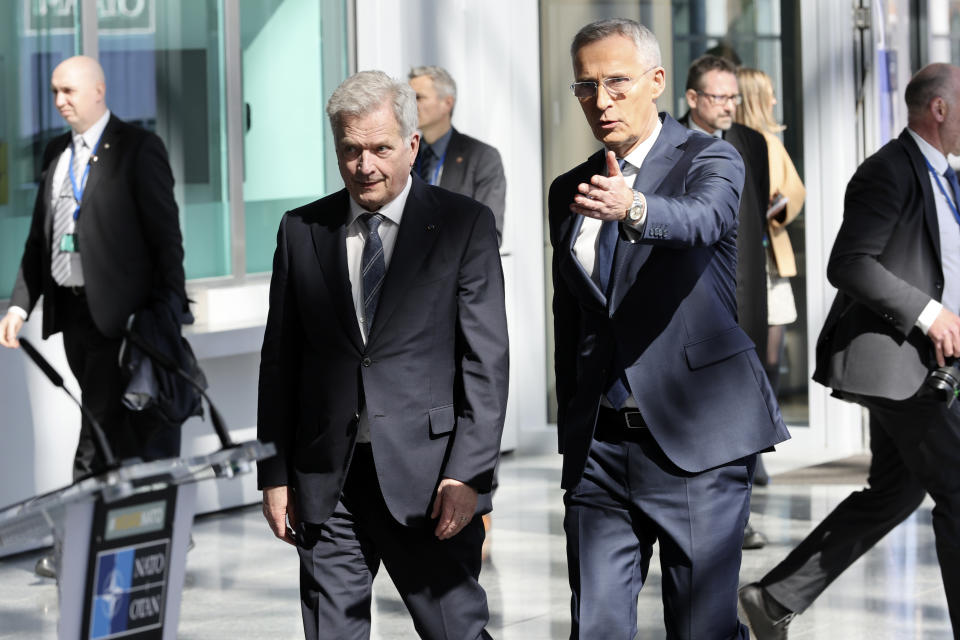 Finland's President Sauli Niinisto, center left, walks with NATO Secretary General Jens Stoltenberg prior to a flag raising ceremony on the sidelines of a meeting of NATO foreign ministers at NATO headquarters in Brussels, Tuesday, April 4, 2023. Finland joined the NATO military alliance on Tuesday, dealing a major blow to Russia with a historic realignment of the continent triggered by Moscow's invasion of Ukraine. (AP Photo/Geert Vanden Wijngaert)