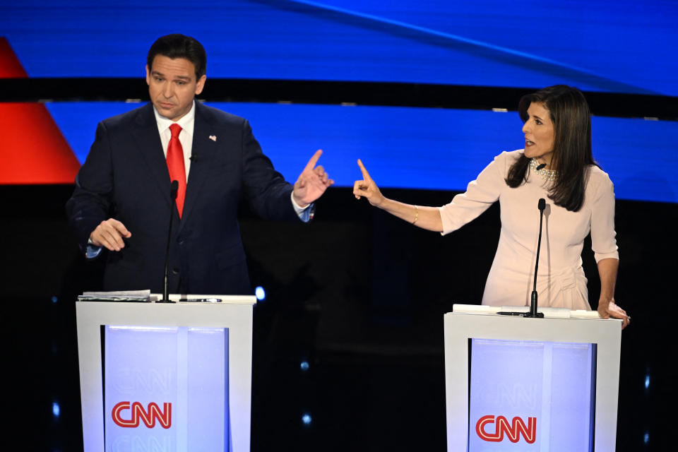 Florida Governor Ron DeSantis (L) and former US Ambassador to the UN Nikki Haley speak during the fifth Republican presidential primary debate at Drake University in Des Moines, Iowa, on January 10, 2024. (Photo by Jim WATSON / AFP) (Photo by JIM WATSON/AFP via Getty Images)