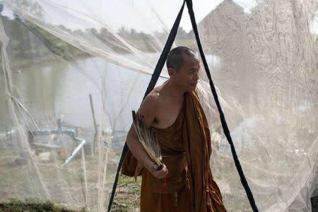 Phra Buddha Issara walks inside his garden during an interview with Reuters at Wat Or Noi in Nakhon Pathom February 27, 2015. REUTERS/Athit Perawongmetha