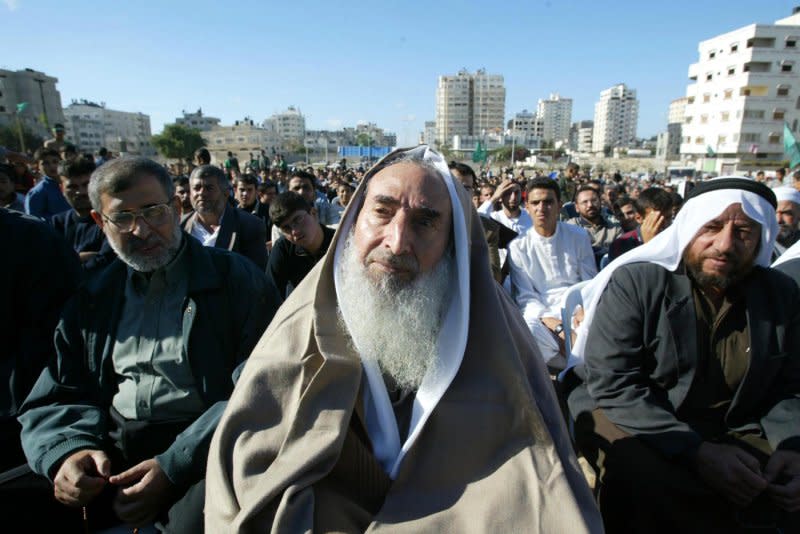Palestinian Hamas spiritual leader Sheik Ahmed Yassin (C) is surrounded by supporters chanting slogans at a demonstration in Gaza City on November 14, 2003. On March 22, 2004, Yassin was killed in an Israeli missile strike in the Gaza Strip. File Photo by Ismail Mohamad/UPI
