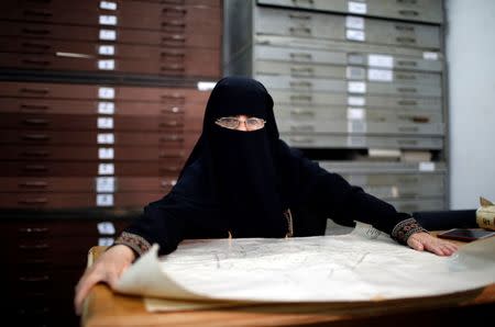 Ettaf Shehada, Director of the Archives at Gaza Land Authority, displays a map showing lands from the British era, in Gaza City June 19, 2018. Picture taken June 19, 2018. REUTERS/Mohammed Salem