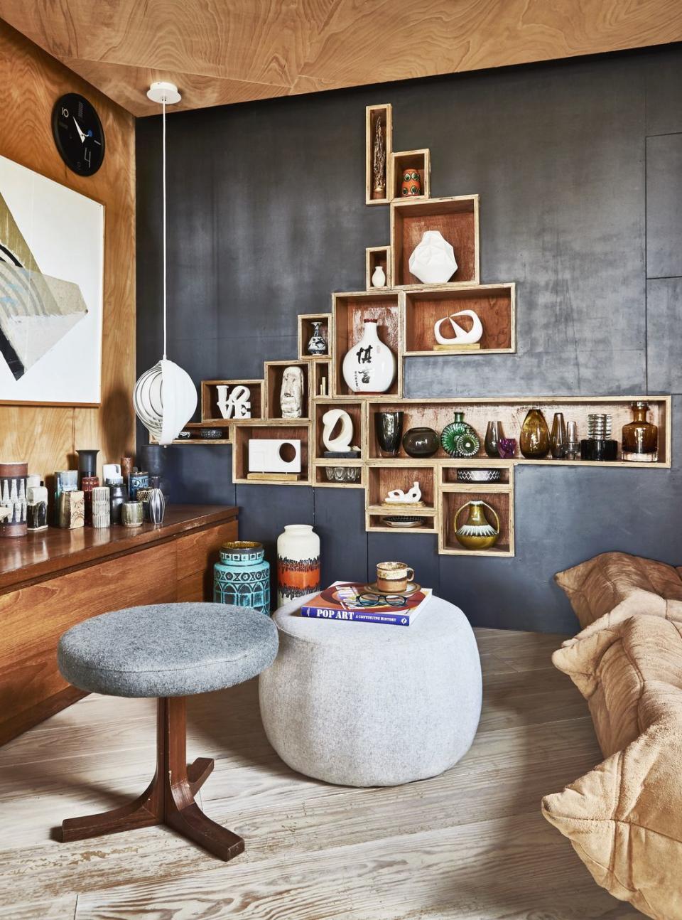 a room with a table and shelves with objects on it