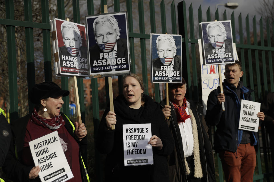 Supporters of Julian Assange hold placards as they protest on the second day of a week of opening arguments for the extradition of Wikileaks founder Julian Assange outside Belmarsh Magistrates' Court in south east London, Tuesday, Feb. 25, 2020. U.S. authorities, want to try Assange on espionage charges. A lawyer for the Americans said the Australian computer expert was an “ordinary” criminal whose publication of hundreds of thousands of secret military documents put many people at risk of torture and death. (AP Photo/Matt Dunham)