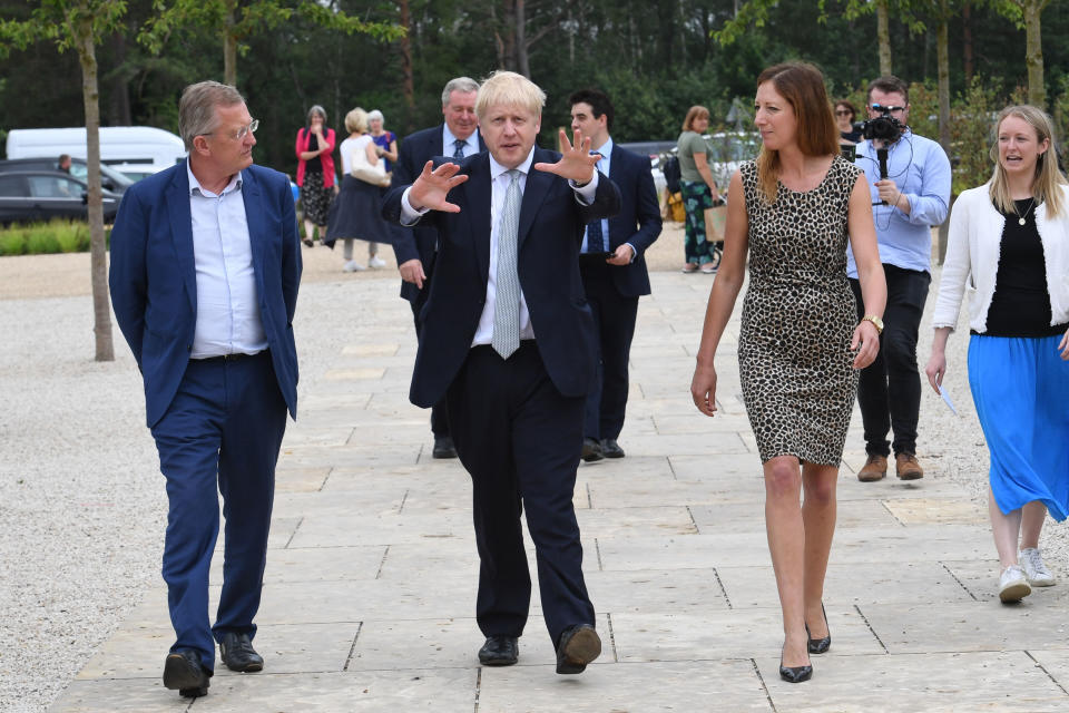 RETRANSMISSION adding name of Hayley Monckton. Conservative party leadership candidate Boris Johnson (centre) walks with David Alexander (left, Director of Estates at the RHS) and Hayley Monckton (front right, Director of Communications at the RHS) while touring the RHS (Royal Horticultural Society) garden at Wisley, in Surrey.