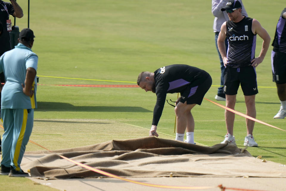 England's coach Brendon McCullum, second right, examines the pitch preparing for 1st test cricket match between England and Pakistan, before a practice session, in Multan, Pakistan, Sunday, Oct. 6, 2024. (AP Photo/Anjum Naveed)