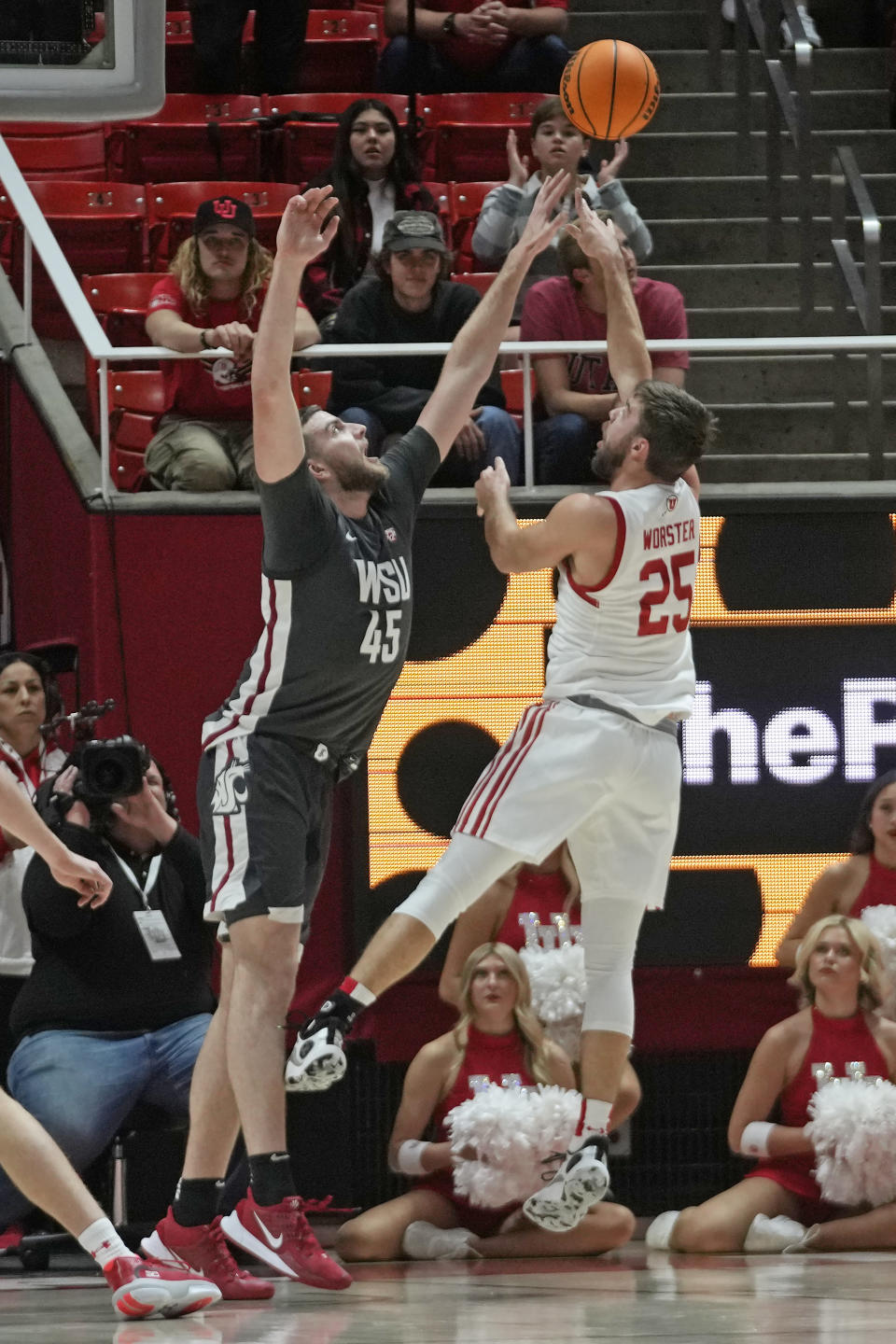 Utah guard Rollie Worster (25) shoots as Washington State forward Oscar Cluff (45) defends during the first half of an NCAA college basketball Friday, Dec. 29, 2023, in Salt Lake City. (AP Photo/Rick Bowmer)