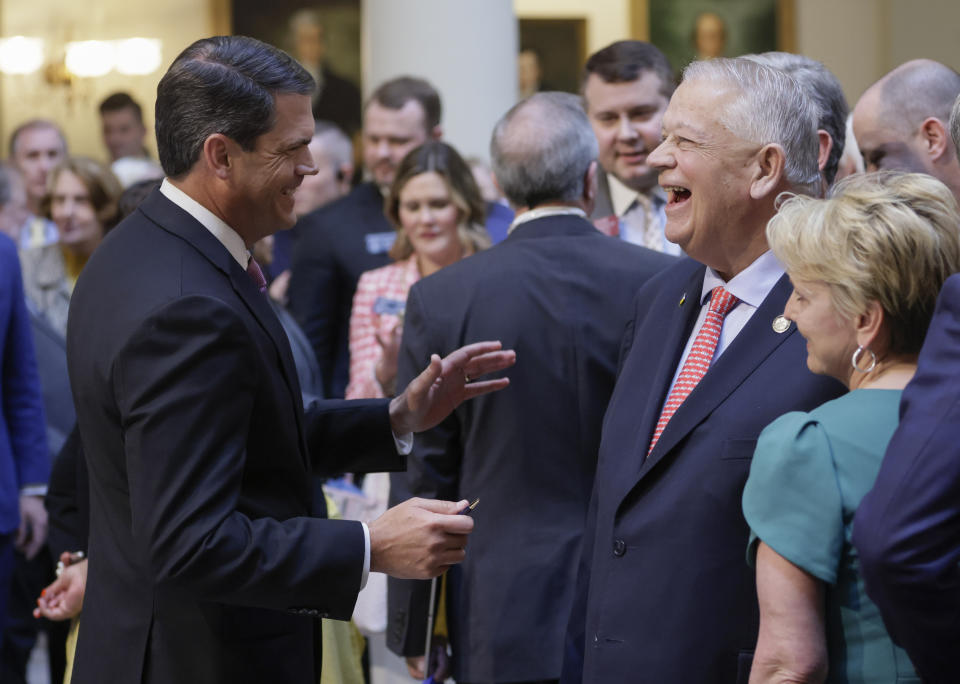 Lt. Gov. Geoff Duncan and House Speaker David Ralston share a laugh after Gov. Brian Kemp signed HB 1013, which aims to increase access to mental health coverage in Georgia on Sine Die, the last day of the General Assembly at the Georgia State Capitol in Atlanta on Monday, April 4, 2022. (Bob Andres/Atlanta Journal-Constitution via AP)