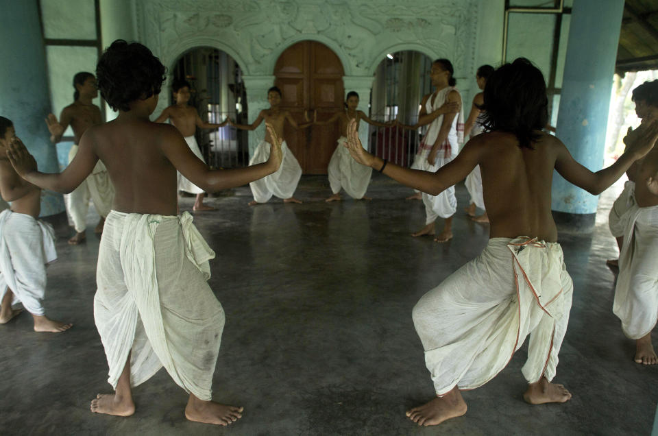 In this Tuesday, Aug. 7, 2018, photo, young Hindu monks practice Mati Akhora devotional performing art at a Satra, or Vaishnavite monastery, in Majuli, India. This centuries-old tradition is being kept alive in Majuli island, one of the world’s largest river islands, home to more than 20 Vaishnavite monasteries. Vaishnavism is a religious movement, a monotheist offshoot of Hinduism that reveres God Vishnu and one of his most popular reincarnations, Krishna. (AP Photo/Anupam Nath)