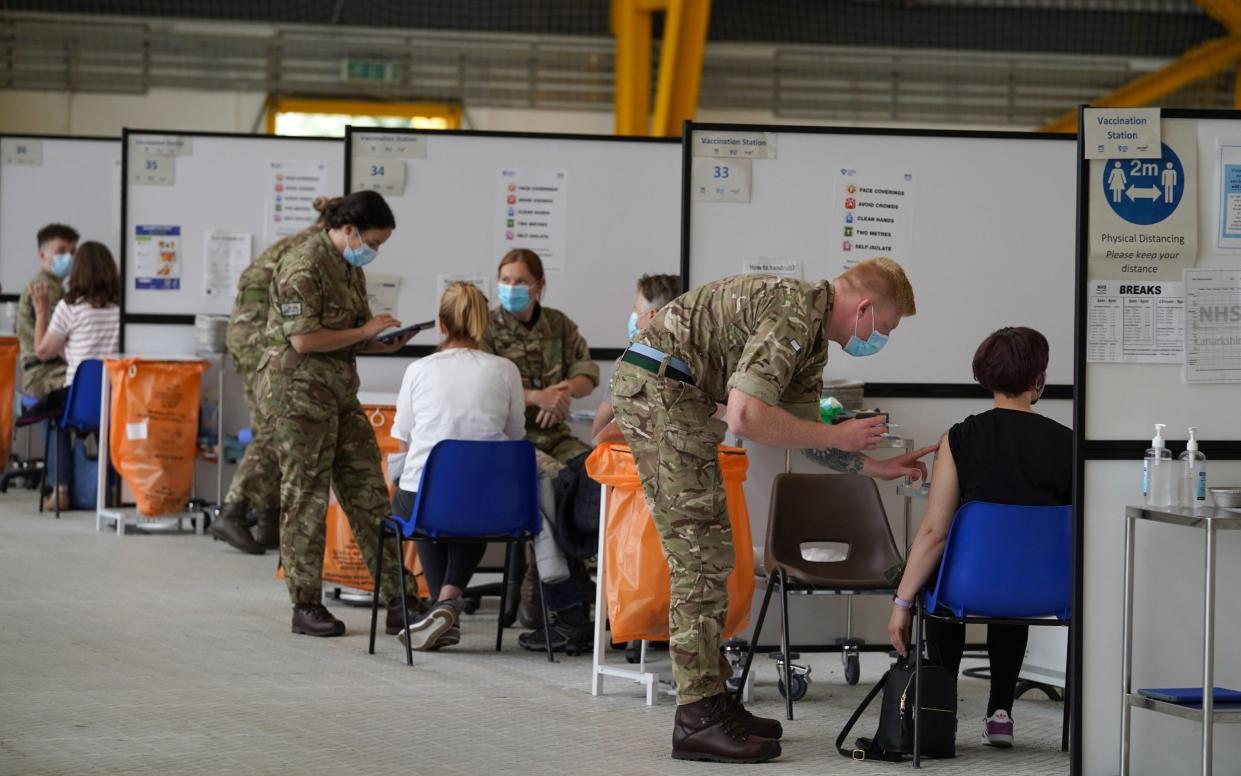 Members of the Armed Forces administer vaccinations at the vaccination centre at Ravenscraig Regional Sports Facility in Motherwell, Scotland - Andrew Milligan 