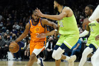 Phoenix Suns guard Chris Paul (3) drives as Minnesota Timberwolves center Karl-Anthony Towns (32) defends during the second half of an NBA basketball game, Friday, Jan. 28, 2022, in Phoenix. The Suns defeated the Timberwolves 134-124. (AP Photo/Matt York)