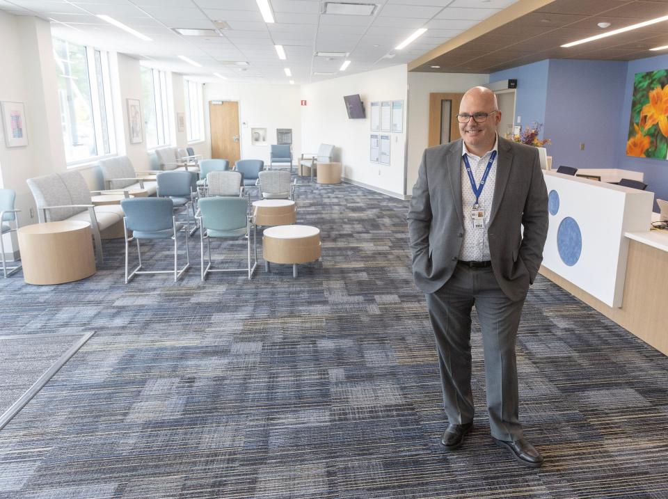 Doug Straight, director of Akron Children's behavioral health service line, talks about some of the amenities in the new Canton facility's lobby.