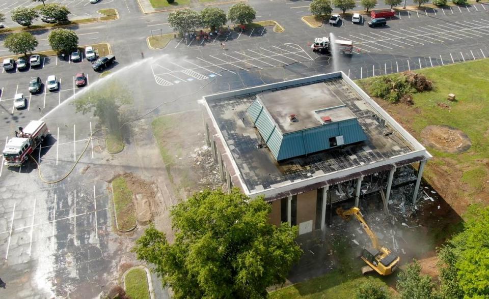 A Macon-Bibb County excavator begins the tear down of the former Greater Chamber of Commerce building Wednesday morning located at 305 Coliseum Drive. The removal of the building will increase parking for the Macon Coliseum.