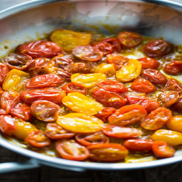 Tomatoes simmering in a pan.