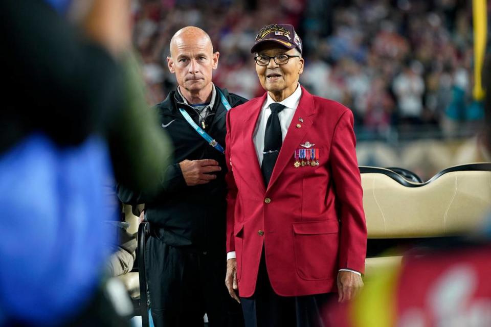 Col. Charles McGee, right, a Tuskegee Airmen during World War II, participates in the coin toss before the NFL Super Bowl 54 football game between the San Francisco 49ers and the Kansas City Chiefs Sunday, Feb. 2, 2020, in Miami Gardens, Fla. (AP Photo/David J. Phillip)