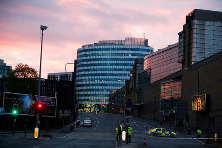 The sun rises as police stand guard outside the Manchester Arena in Manchester, Britain May 23, 2017. REUTERS/Andrew Yates