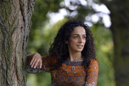 Masih Alinejad, 37, a Britain-based Iranian journalist, poses for a portrait in London October 8, 2013. Alinejad, a former reporter in Iran, left the country a week before the 2009 elections to study abroad and stayed outside after the unrest and crackdown on reformist press. REUTERS/Toby Melville